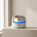 Decorative lamp with a moon and mountain design on a white surface.