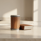 Wooden container with metal lid on a light surface