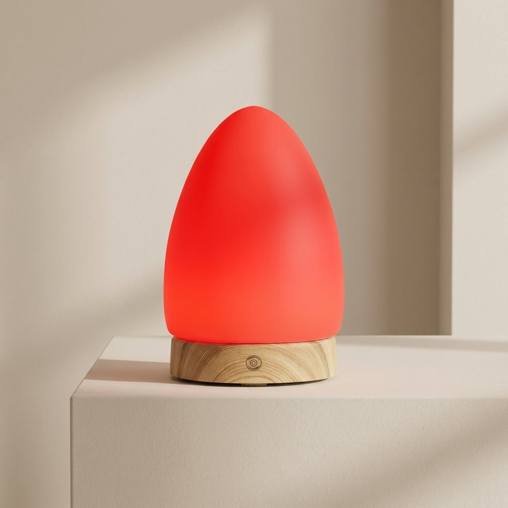 Red lamp with wooden base on a beige surface