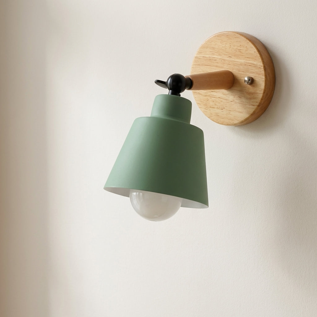 Wall-mounted light fixture with a green shade and wooden base on a white wall.