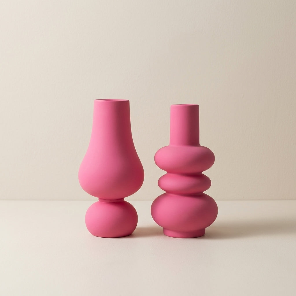 Two pink vases on a beige background