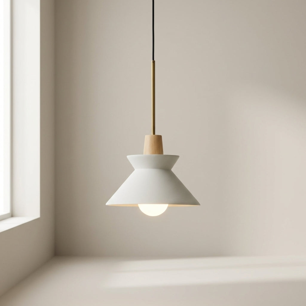 Modern pendant light hanging in a room with neutral walls and a window.
