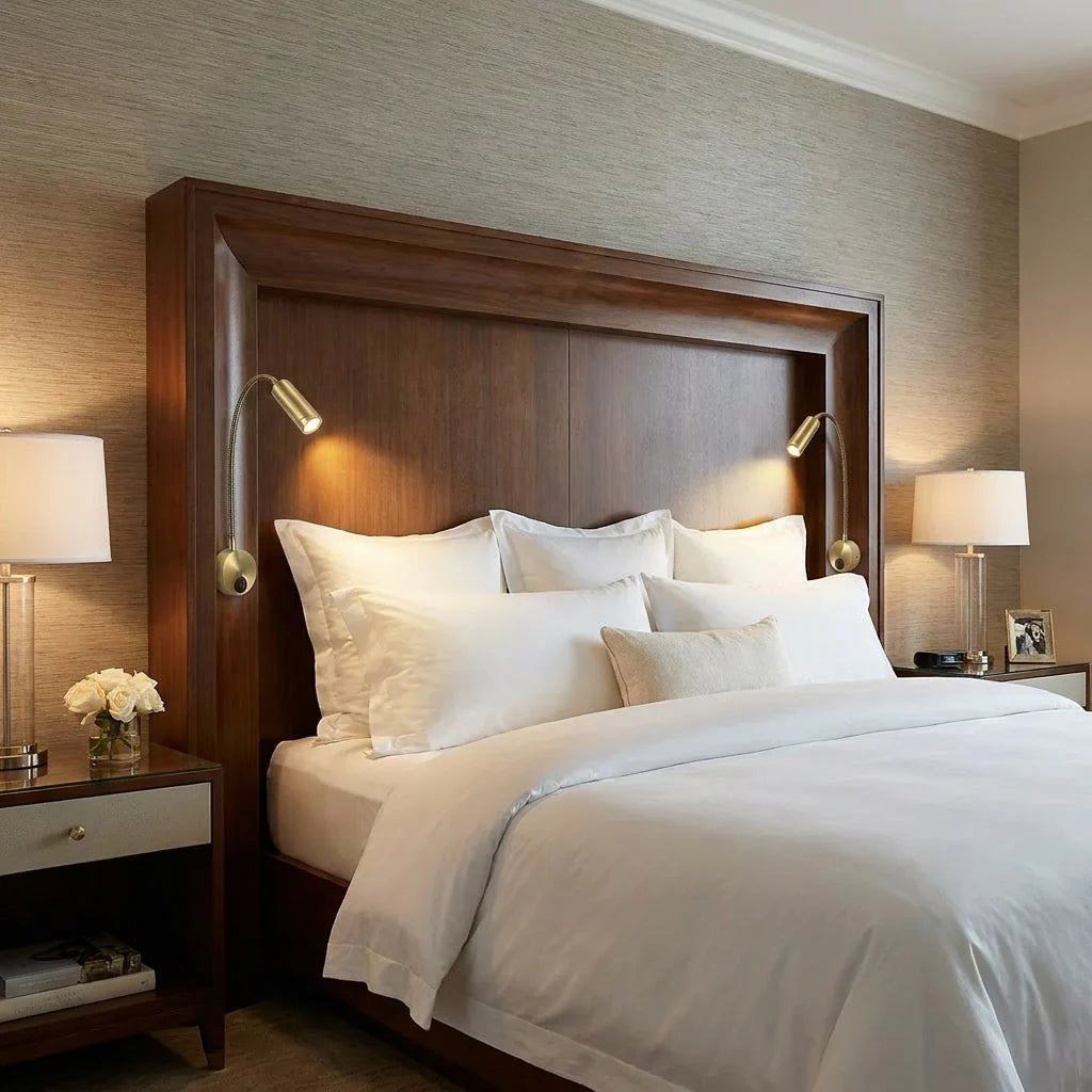 Neatly made bed with white bedding in a bedroom setting.