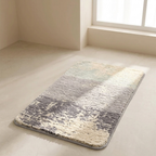 Gradient rug on a light wooden floor with a window in the background