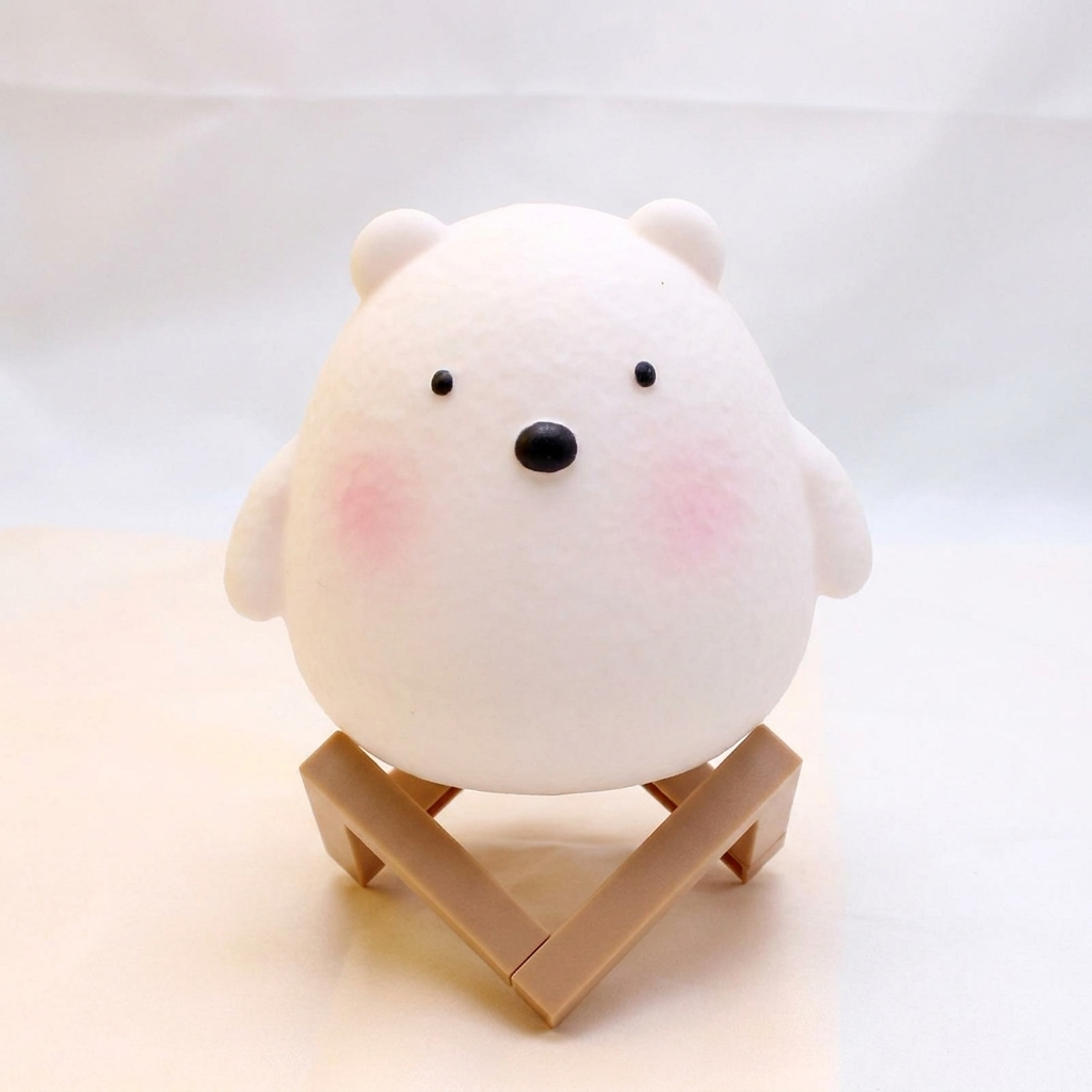 White bear-shaped object on a small wooden stand against a light background