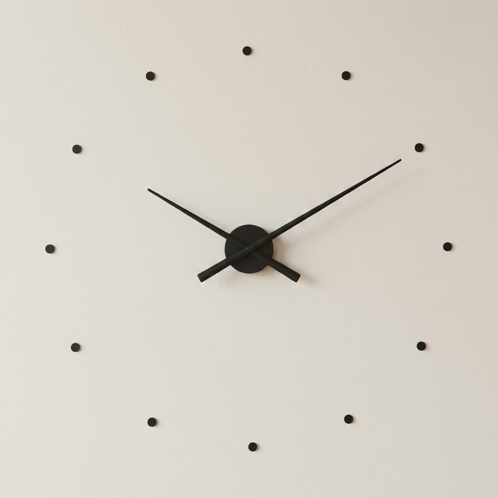 Black wall clock with minimalistic design on a light gray background