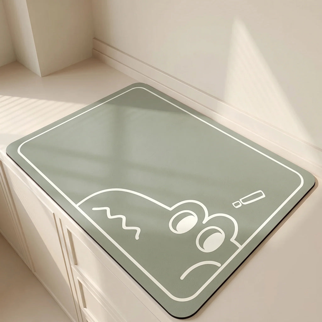 Green mat with a white cartoon design on a light wooden floor.