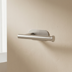 Metal door handle on a beige wall