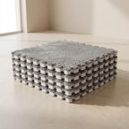 Stack of interlocking foam blocks with a textured surface on a plain floor.