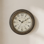 Vintage-style wall clock on a beige wall