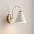 Wall-mounted lamp with white shade and wooden base on a beige wall