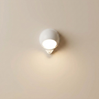 White wall-mounted light fixture on a beige wall