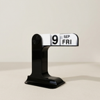 Black and white perpetual calendar on a beige background
