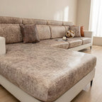 Beige sectional sofa in a living room setting with decorative pillows and a small table.