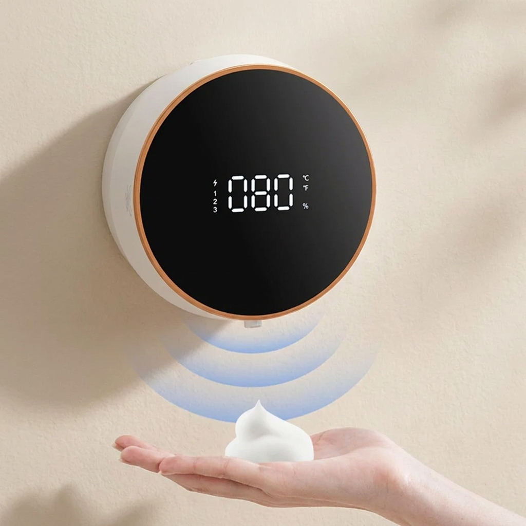 Digital clock with soap dispenser on a beige wall