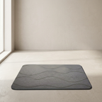 Gray textured mat on a light wooden floor with a neutral wall background