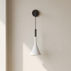 Modern wall-mounted lamp with white cone-shaped shade and black fixture on a neutral wall.
