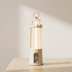 Decorative lantern with a warm glow on a wooden surface against a neutral background