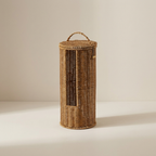 Wicker laundry basket with a handle on a beige background