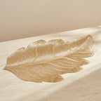Gold leaf on a beige surface