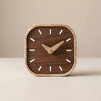 Wooden clock with white hour markers on a beige background
