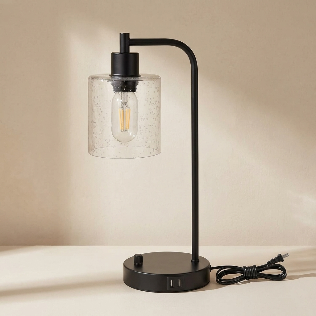 Black table lamp with a clear glass shade on a beige background