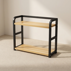 Two-tier shelf with black metal frame and wooden shelves on a neutral background