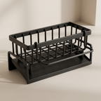 Black metal dish rack on a beige background