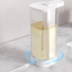 White soap dispenser with liquid soap on a marble surface