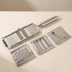 Multi-functional metal slicer with interchangeable blades on a beige background