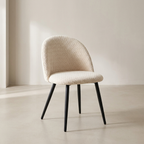 Beige chair with black legs in a minimalistic setting