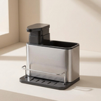 Silver and black kitchen sink caddy on a beige countertop