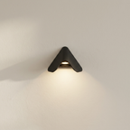 Modern wall-mounted light fixture on a neutral wall