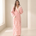 Woman wearing a pink plush robe in a bright room