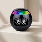 Black digital clock with colorful top on a beige surface