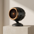 Decorative black and gold object on a light gray pedestal against a neutral background