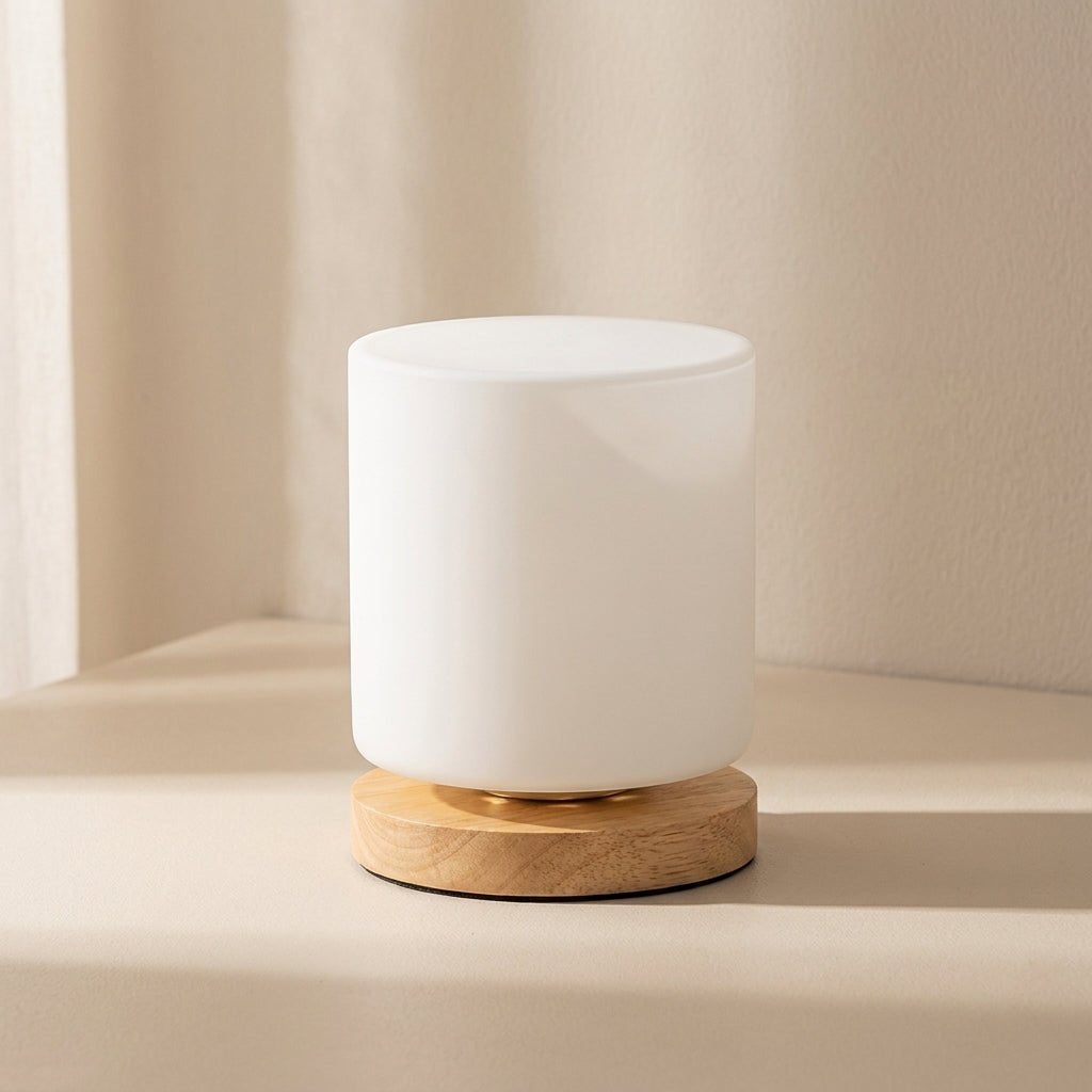White cylindrical lamp with wooden base on a beige background