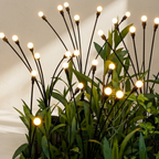 Decorative plant with illuminated branches against a neutral background