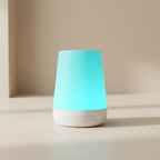 Tall, cylindrical device with a turquoise top and white base on a neutral background