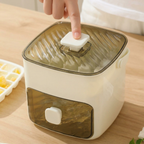 Hand pressing a button on a transparent container with a white base on a wooden surface.