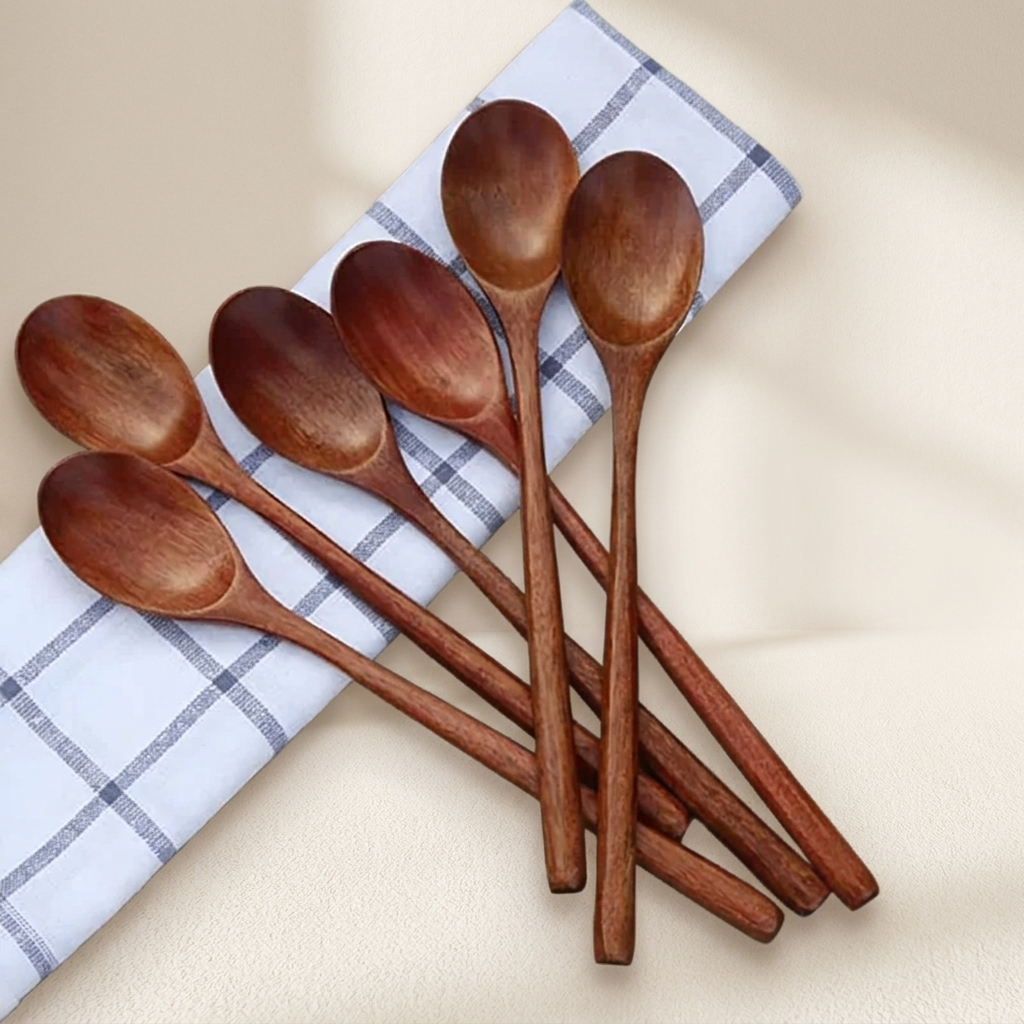 Set of wooden spoons on a checkered cloth with a beige background
