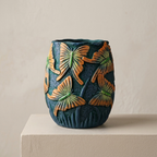 Ceramic vase with butterfly design on a beige surface and background