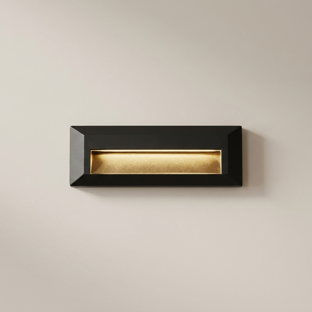 Black letterbox with gold interior on a beige wall