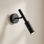 Black wall-mounted light fixture on a beige background