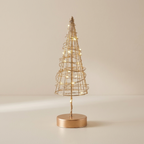 A gold wire spiral Christmas tree table lamp with warm white LED lights, standing on a round metallic gold base against a neutral beige background.