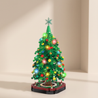 A small green LEGO-style Christmas tree with colorful ornaments and glowing lights, standing on a round base against a warm beige studio background.