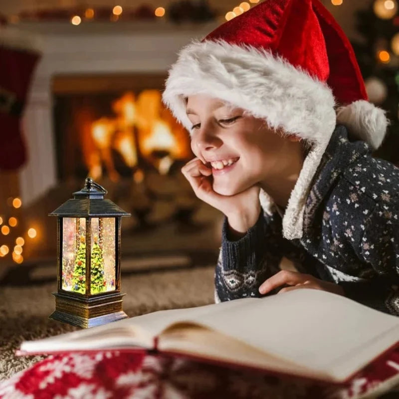 A child wearing a red Santa hat and dark patterned sweater lies on the floor by a warm fireplace, smiling at an open book with a glowing lantern nearby.