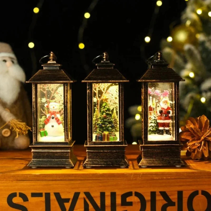 Three decorative lanterns with Christmas scenes inside, on a wooden surface with festive decorations.