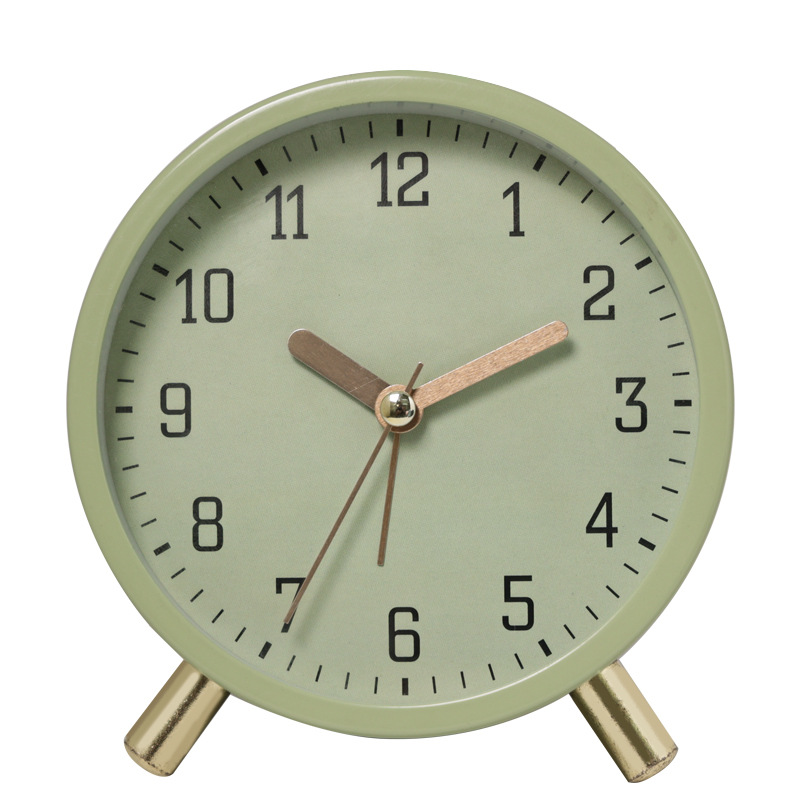 Green clock with gold accents on a white background