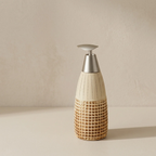 Decorative bottle with woven design and metallic cap on a beige background